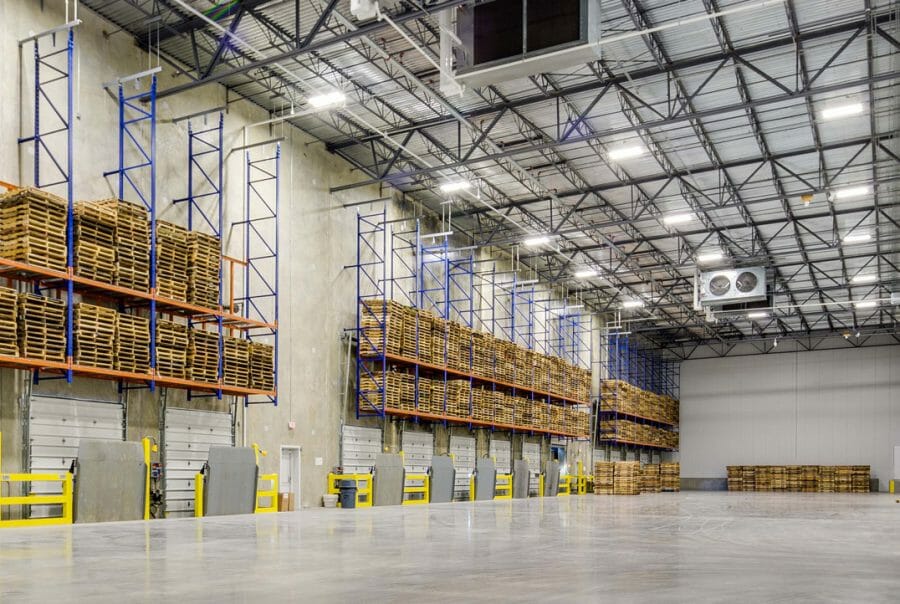 warehouse and distribution center receiving area with empty pallets stacked