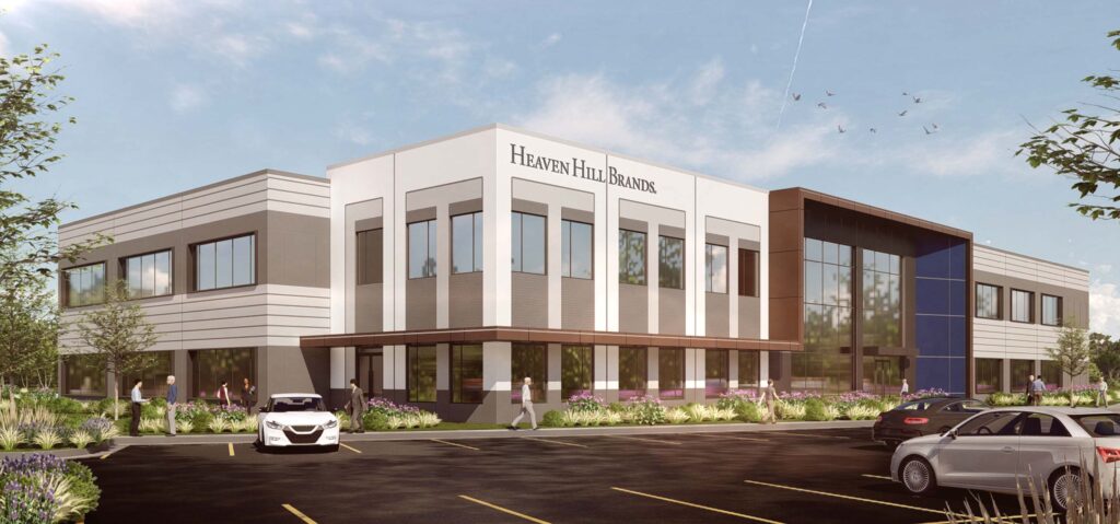 Modern office building of Heaven Hill Brands with large windows, surrounded by cars and greenery under a clear blue sky.