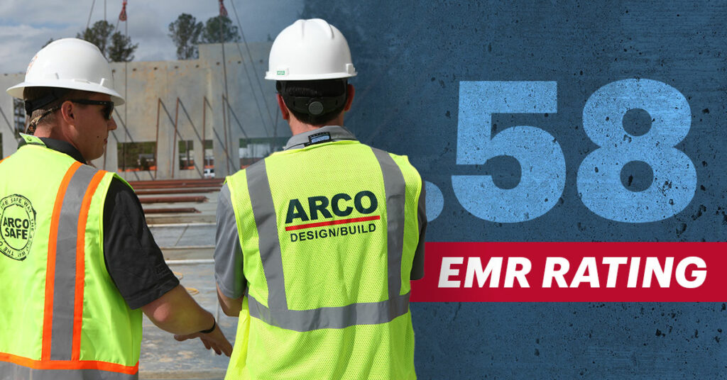 Construction workers in safety gear on site with .58 EMR rating displayed prominently on the image.